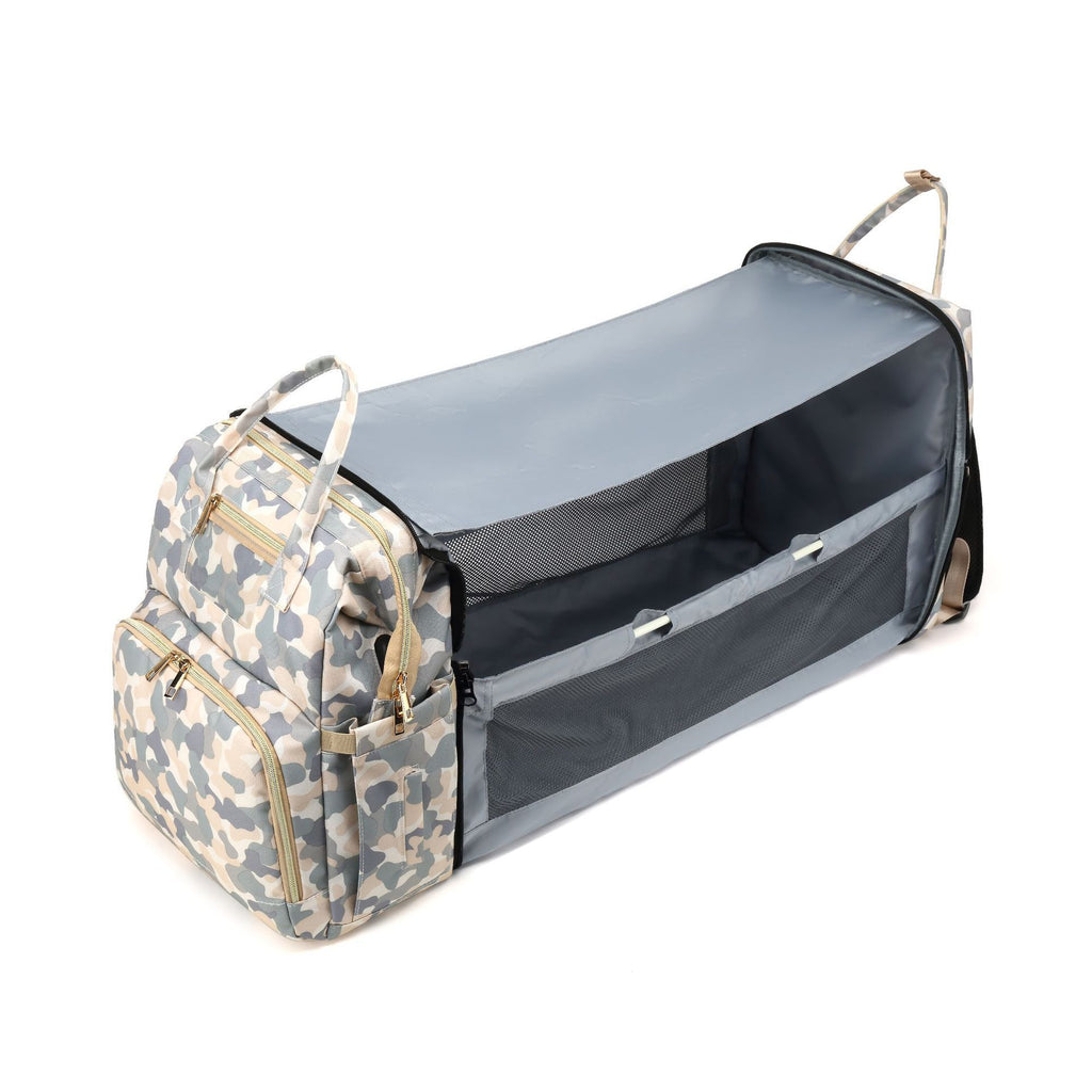 Camouflage diaper backpack unfolded into a long compartment with mesh sides and a raised cover