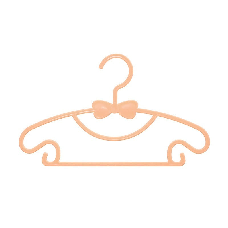 Orange children's clothes hanger with a bow detail and curved shoulder hooks