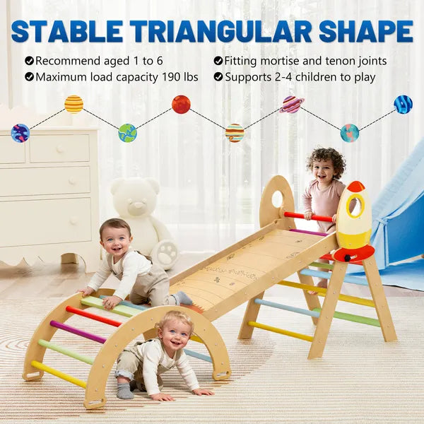 Three children playing on a wooden climbing triangle and arch connected by a ramp, with rocket decorations