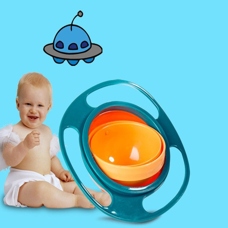 Green rotating snack bowl with an orange inner bowl beside a smiling baby