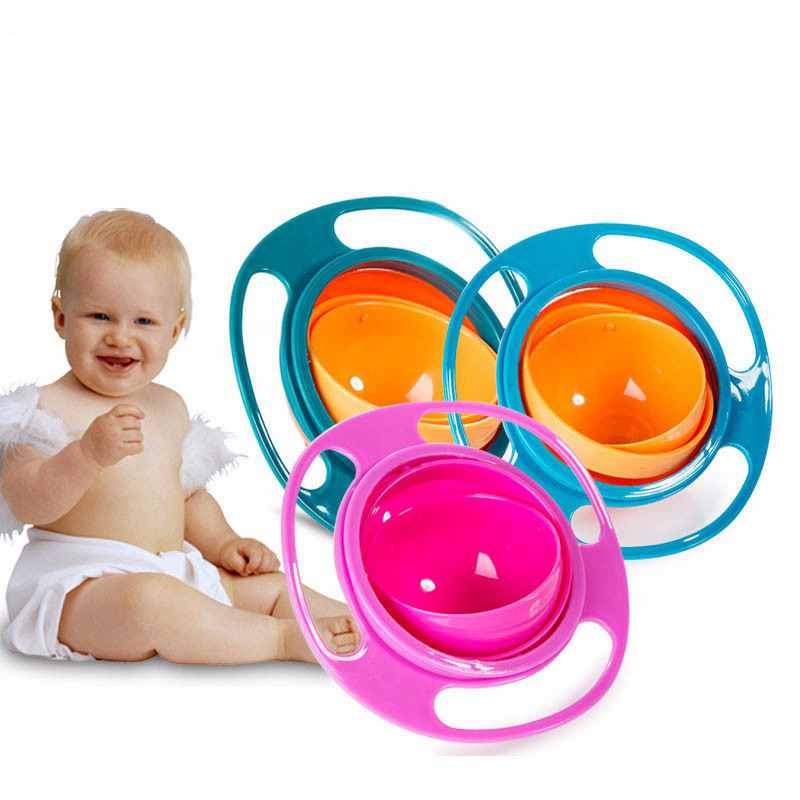 Pink, green and blue rotating snack bowls beside a smiling baby