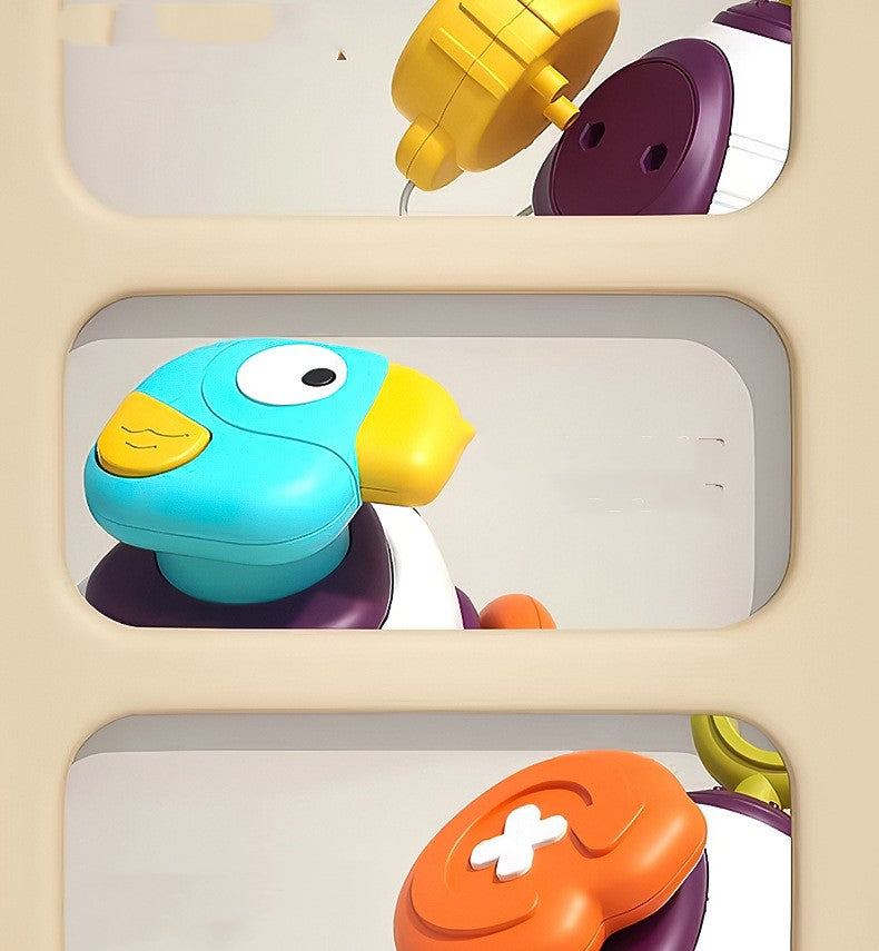 Close-up collage of a baby activity ball showing a removable yellow piece, blue bird and orange panel